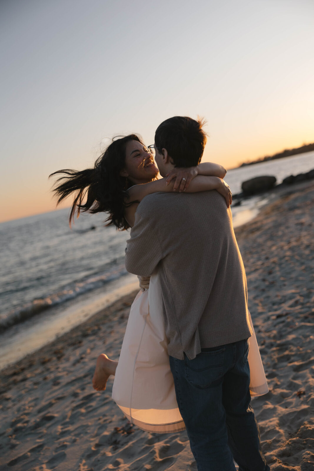 Couple frolicking on beach | New England Wedding Photographer