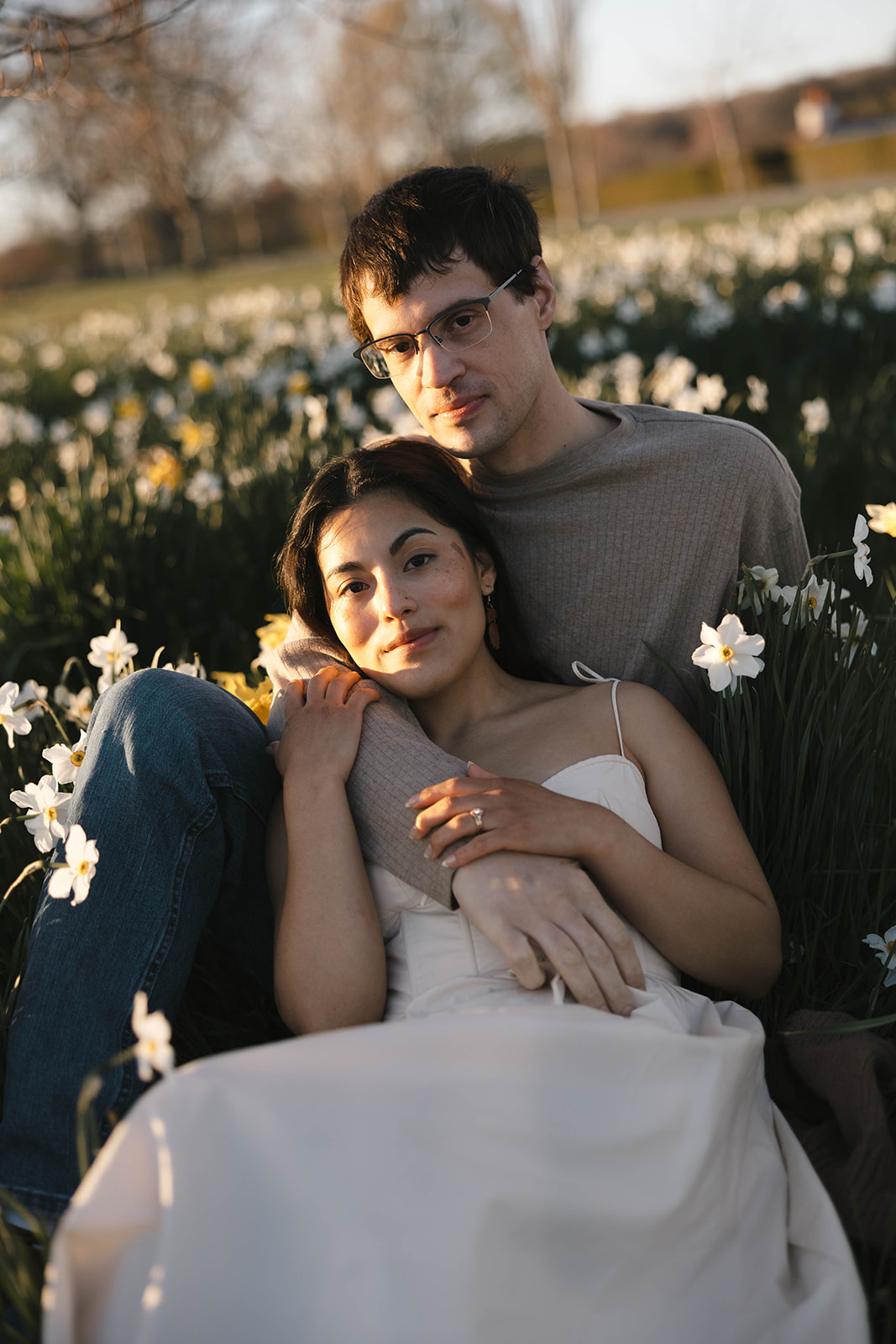 Gaby and Corey holding each other among the blooming flowers