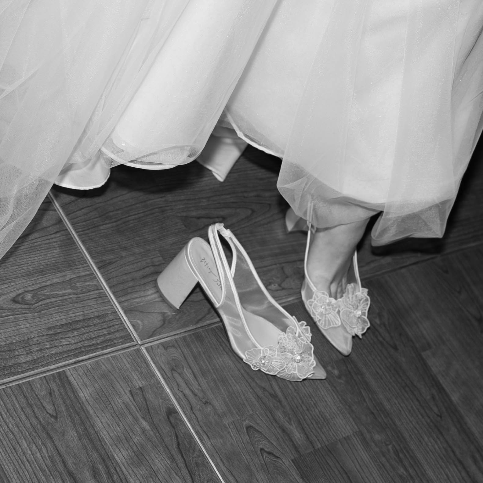 Bride kicking off her shoes for dancing!