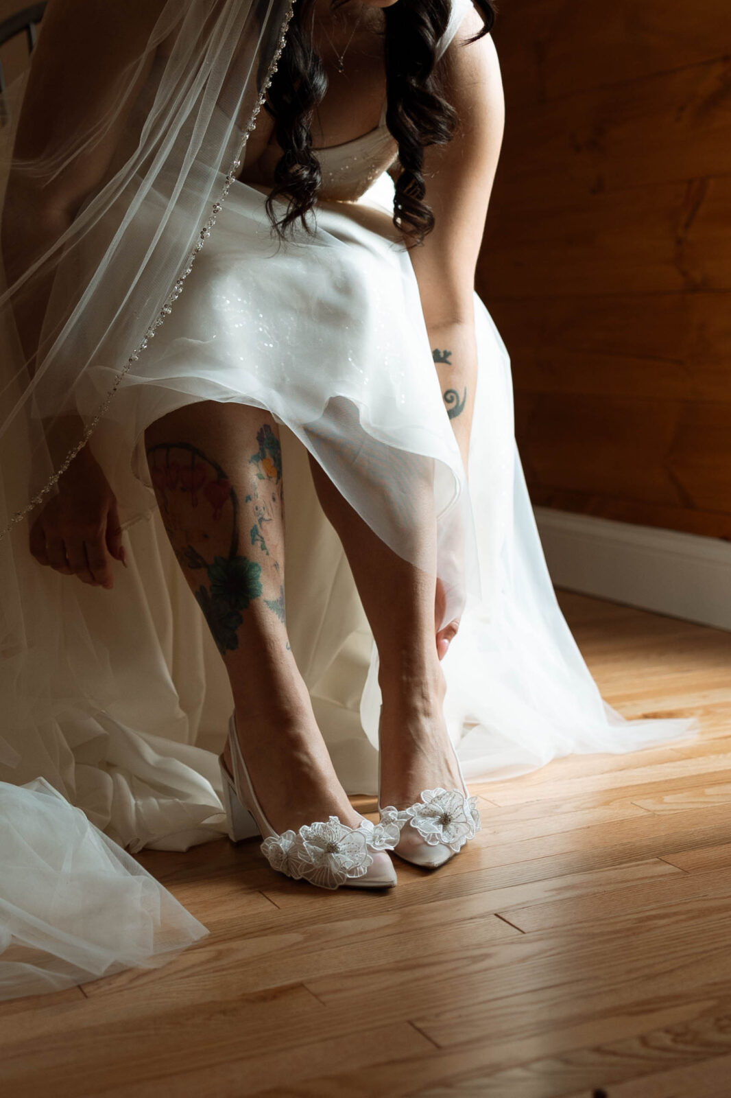 Caitlin putting on wedding shoes