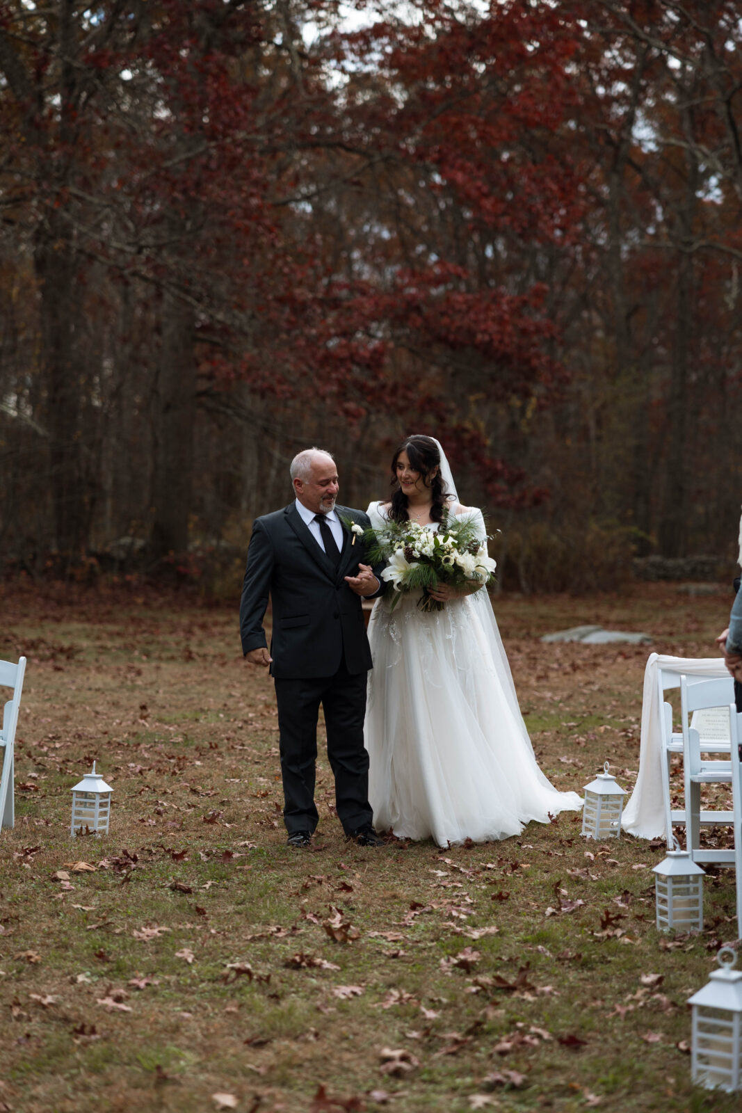 Caitlins father walking her down the aisle to David