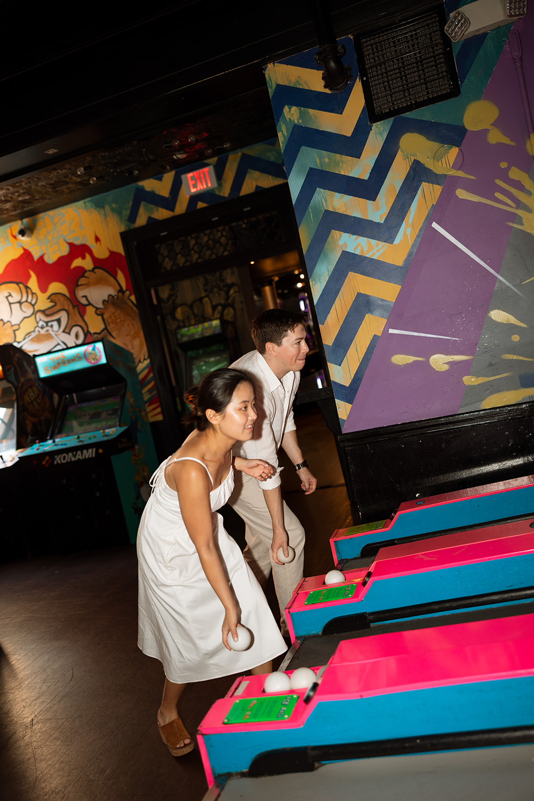 Couple playing skee-ball