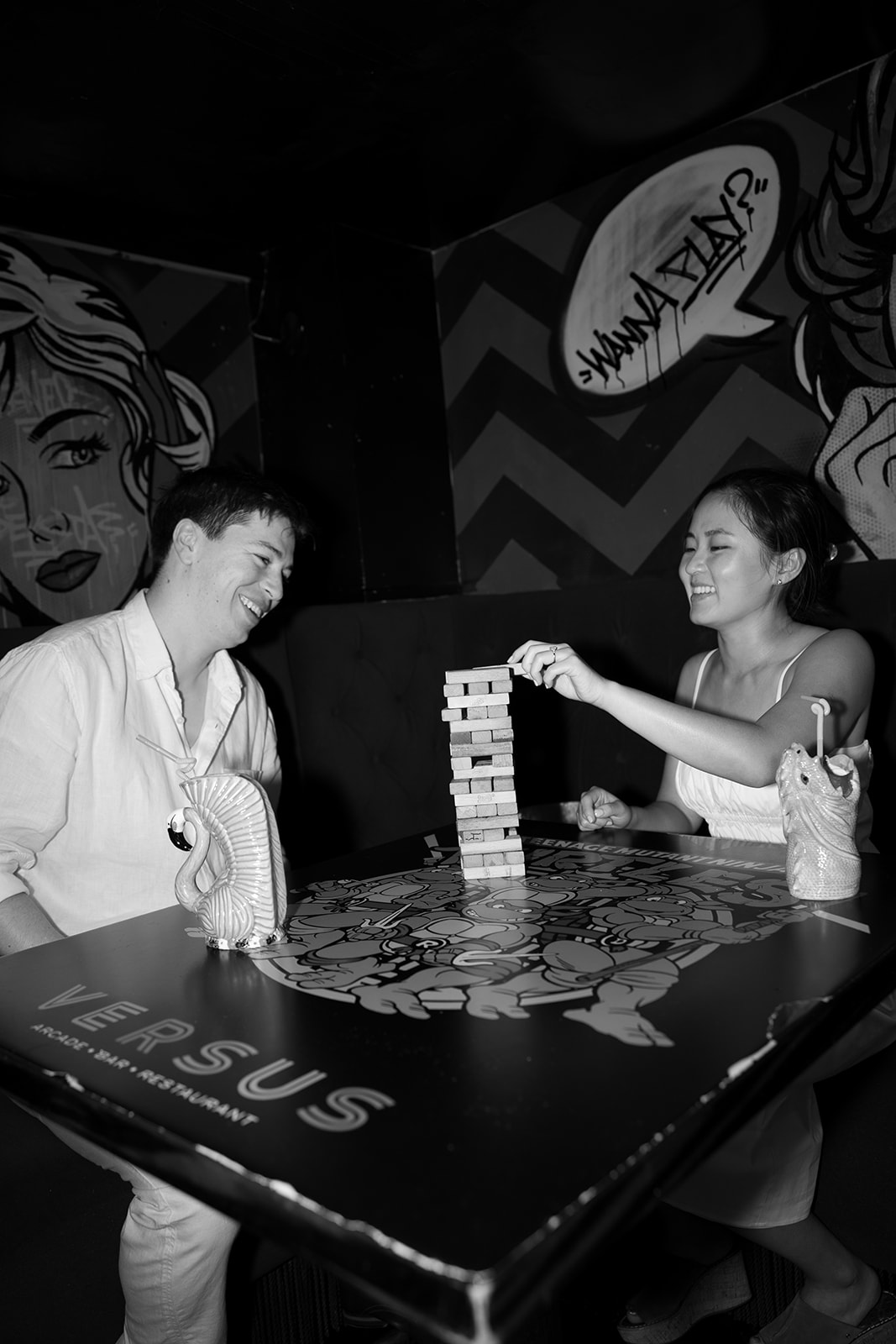 Couple photographed at bar playing Jenga